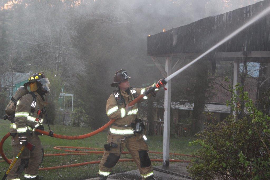 Driver helps Oak Ridge woman to safety after house catches fire